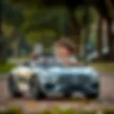 A child enjoying driving a battery-powered Mercedes toy car in a park.