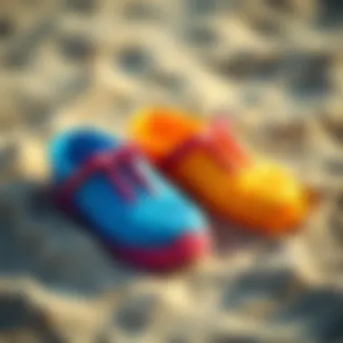 Colorful plastic beach shoes on sand